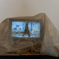 Works from Priscilla Stadler's art project SLUDGE created in response to  toxic Newtown Creek,  NYC, include the video "heal", featuring choreographer/dancer Chris Bisram. Monitor with video draped in weathered cloth found at the Creek.