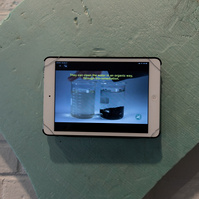 From Priscilla Stadler's SLUDGE, an art project created in response to researching Newtown Creek, a toxic waterway dividing Queens & Brooklyn, NYC. Video mounted diagonal shape scrap of light green foam found at Creek