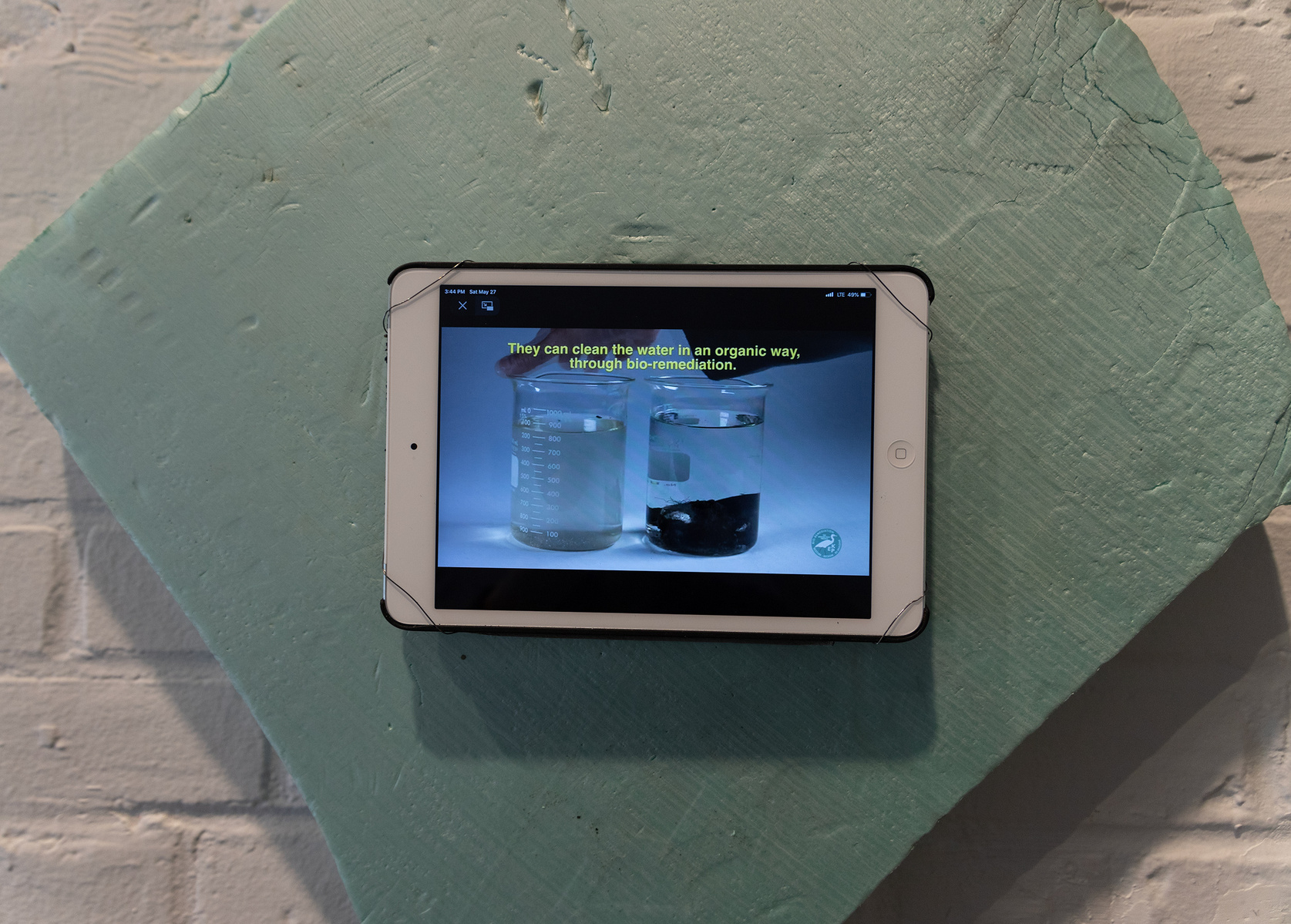 From Priscilla Stadler's SLUDGE, an art project created in response to researching Newtown Creek, a toxic waterway dividing Queens & Brooklyn, NYC. Video mounted diagonal shape scrap of light green foam found at Creek