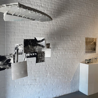 Works from Priscilla Stadler's SLUDGE project, an art installation created in response to researching Newtown Creek, a toxic waterway dividing Queens & Brooklyn, NYC. Left: a sculpture called "Readings"; right: "Troubled Waters 11" (on wall) and "Samples"