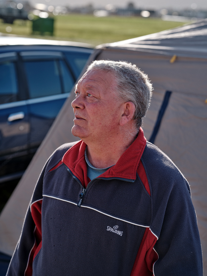 Homeless man Mike, looking up while talking with Scott Gadd.
