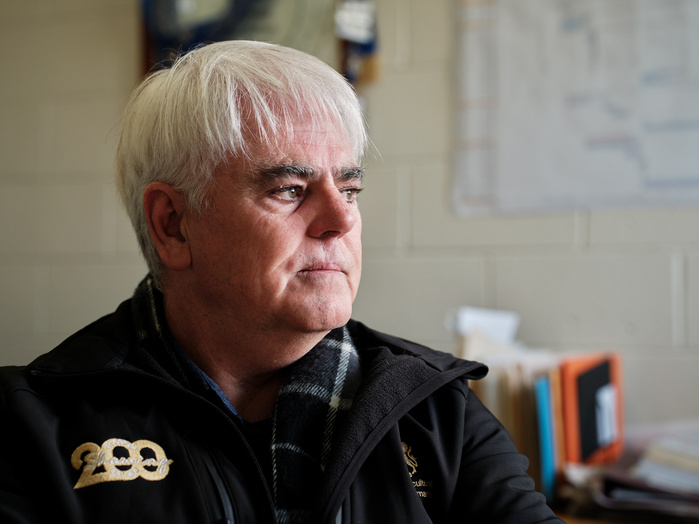 A concerned Scott Gadd talking with Guardian journalist Philippa Duncan in his office.