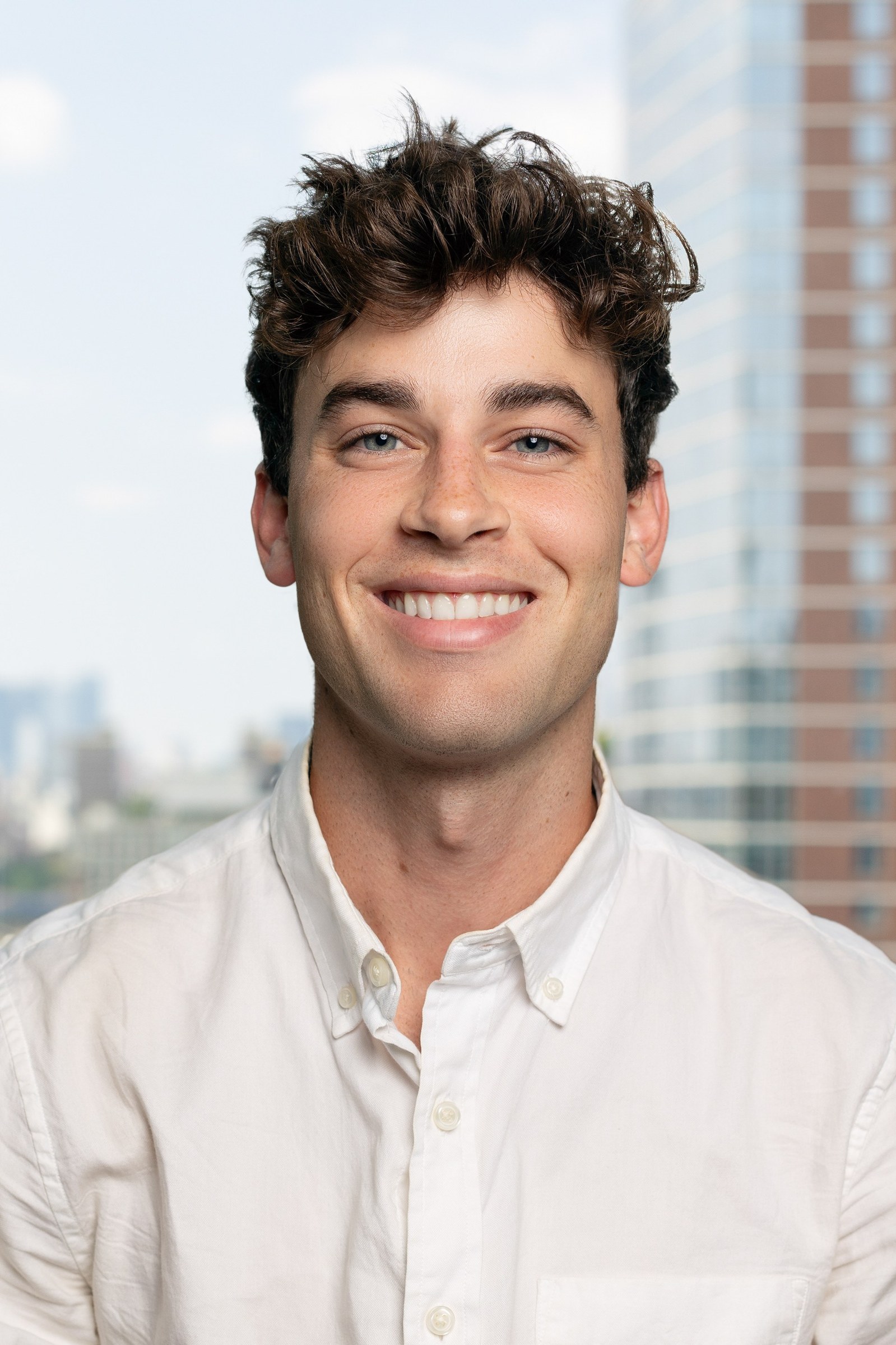Sales Team Headshot with the City Background