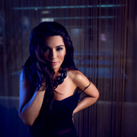 Portrait of Marisol Nichols wearing a black dress and black necklace looking at the camera. 