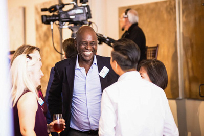 candid image of corporate event attendees engaging with eachother by professional photographer in LA - alissa pagels-minor
