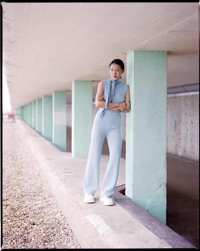 Ruoyi pictured on Hastings seafront wearing CARCEL top and trousers
