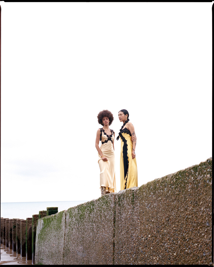 Photo of Scarlett Landy and Ruoyi on Hastings sea wall wearing LORETTA CAPONE dresses