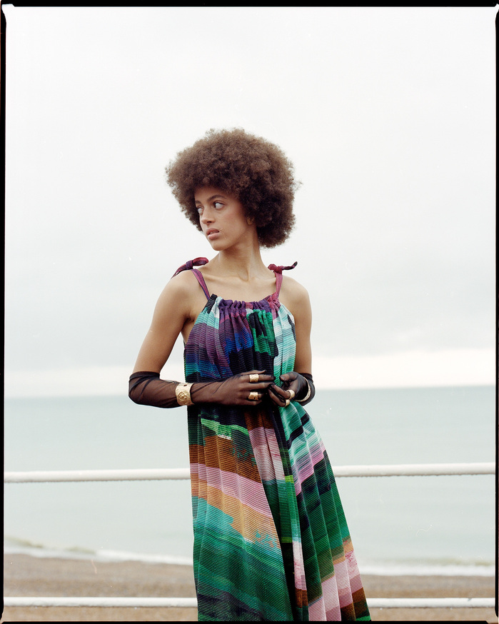 shot of Scarlett Landy on the promenade in Hastings in a ISSEY MIYAKE dress and PAULA ROWAN gloves
