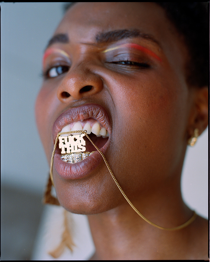 Mireille B. Welcome with FUCK THIS jewellery between her teeth