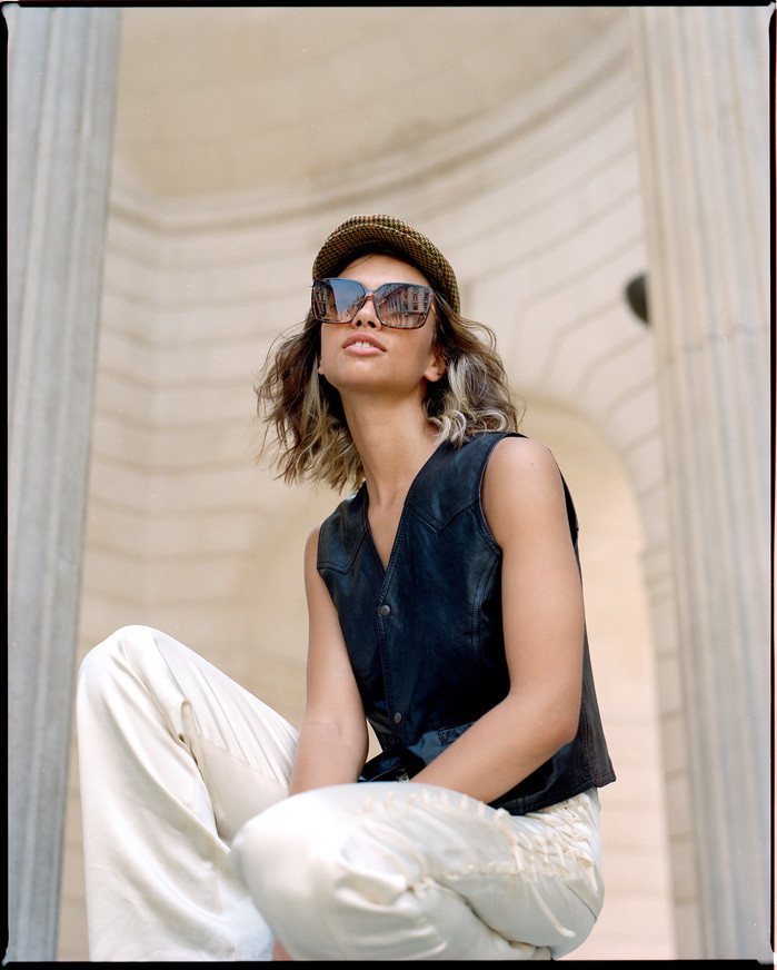 Larissa Diniz in flat cap pictured in City of London