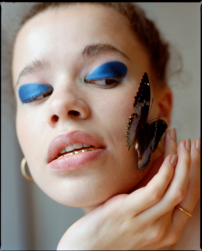 Close-up Anna Oloyede in beauty shot with butterfly on her cheek