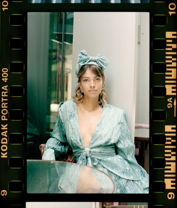 Larissa Diniz in Paula Nadal outfit sat at cafe table