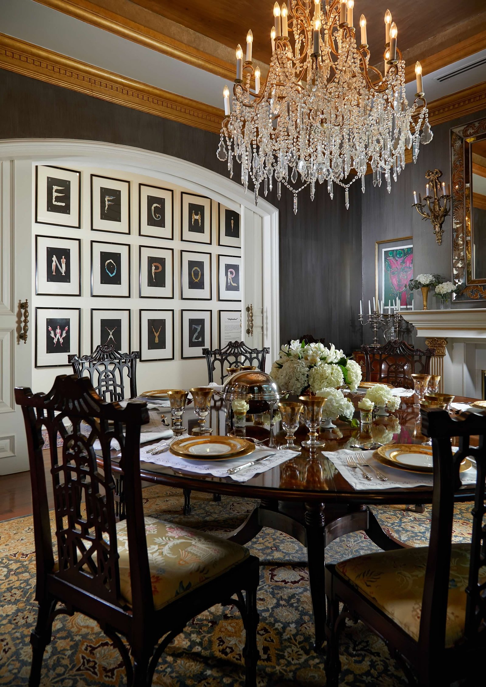 A crystal chandelier, rich wood tones, and classic European details create the ultimate formal dining experience.