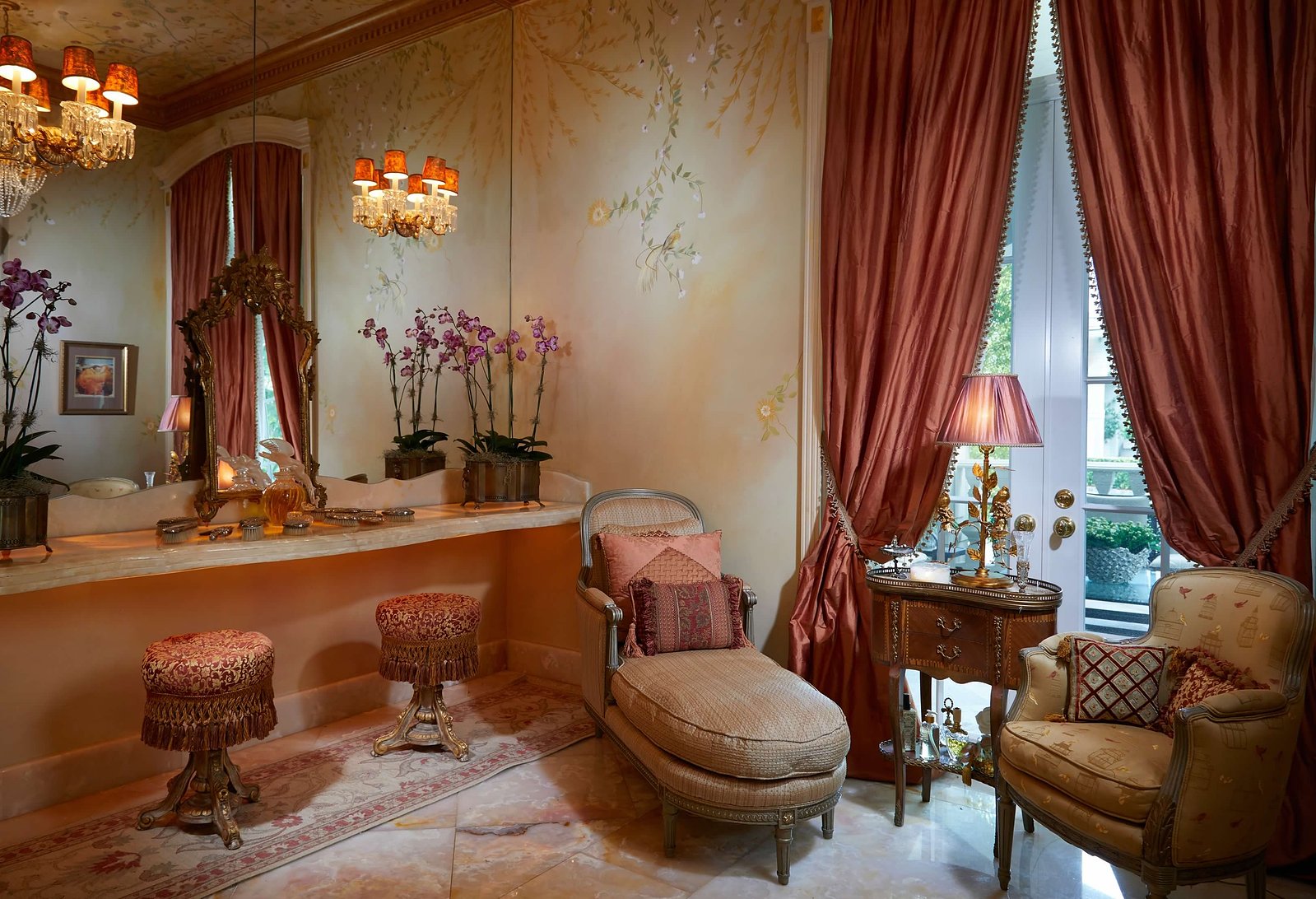 A refined vanity and seating area featuring antique furnishings, intricate details, and opulent decor in a grand estate.