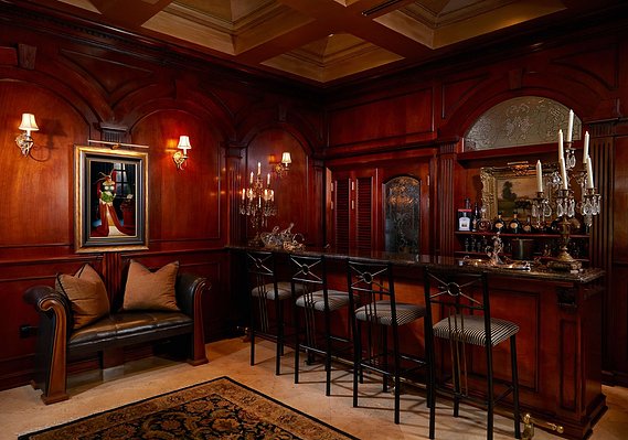 Ornate carvings, rich wood paneling, and candlelit ambiance transform this bar into a classic European escape. 