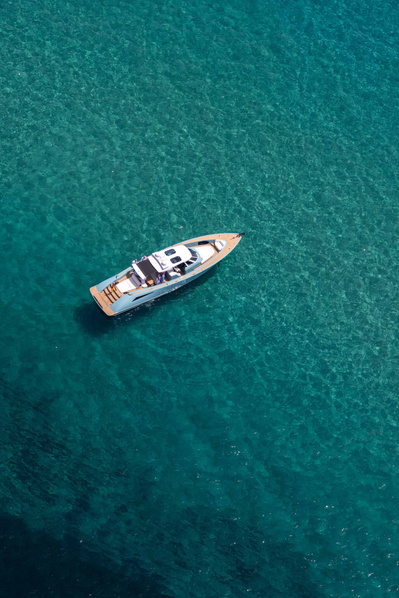 Aerial top view from helicopter of a Wajer yacht in turquoise water in Saint-Tropez, South of France.