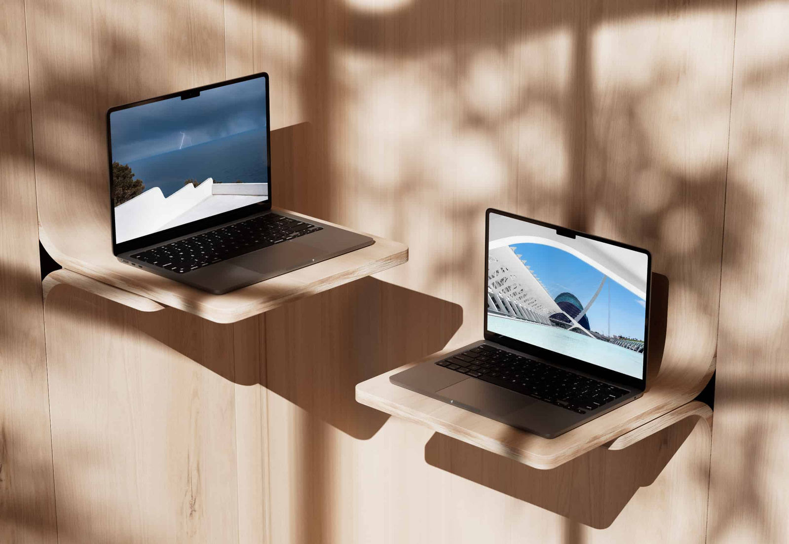 2 MacBook Pro posés sur des meubles avec en fond d'écran des photos de paysages en Espagne. 