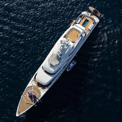 Aerial view from helicopter of a yacht with helicopter on the deck in Saint-Tropez, South of France at sunset.
