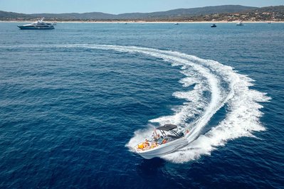 Aerial view from helicopter of a yacht with in front of Pampelonne beach near Saint-Tropez, South of France.