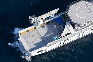 Aerial top view from helicopter of a yacht with basketball field and helicopter deck in Saint-Tropez, South of France.