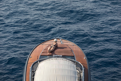 Aerial view from helicopter of a girl in bikini on a yacht in Saint-Tropez, South of France.