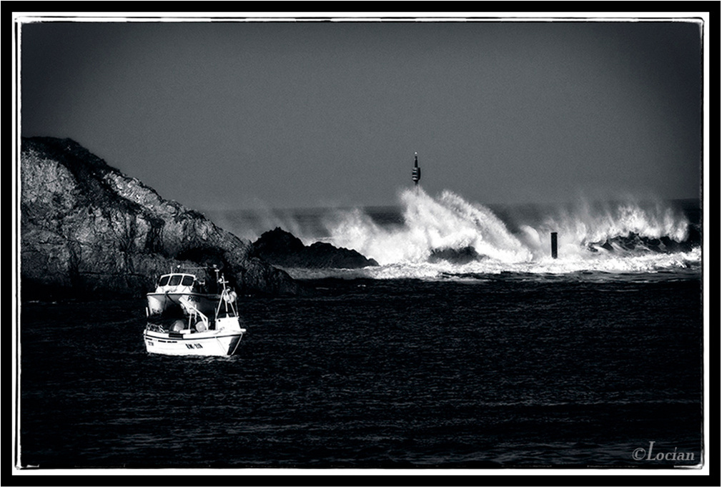 Monochrome image of boats near Barrel Rock on Summerleaze Beach, Bude, Cornwall. Black & White coastal image.