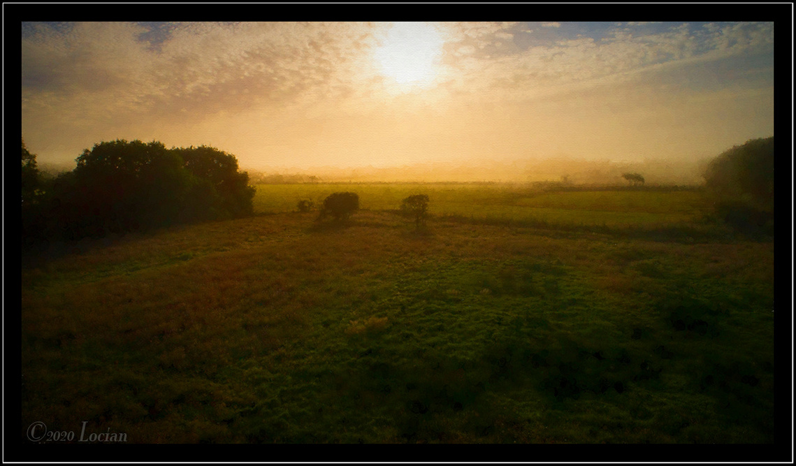 Sunrise across green fields and countryside. Trees semi shrouded in mist. All with a hint of the Masters such as Turner.