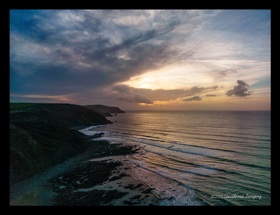 North Cornwall cliffs and beach at Wanson Mouth near Bude. Sunset over the Atlantic Ocean in Kernow.