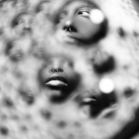 Photograph distorted through soap bubbles by Rielle Oase