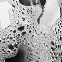 Photograph distorted through soap bubbles by Rielle Oase