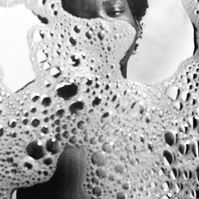 Photograph distorted through soap bubbles by Rielle Oase