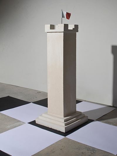 Over sized chess piece, the Castle is part of an installation made of building construction materials - reinforced concrete, stainless steel, enamel paint