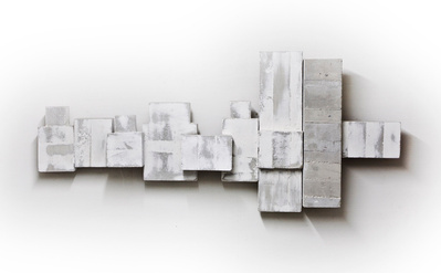 A monochromatic architectonic cubic sculpture made of cast concrete with white plaster