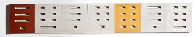 A row of architectonic cubic sculptural parts made of cast concrete with some painted surfaces.