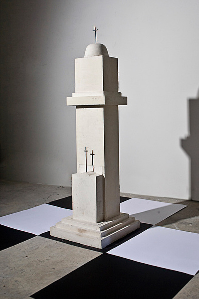 Over sized chess piece, the Bishop, The Rook is part of an installation made of building construction materials - reinforced concrete, stainless steel.