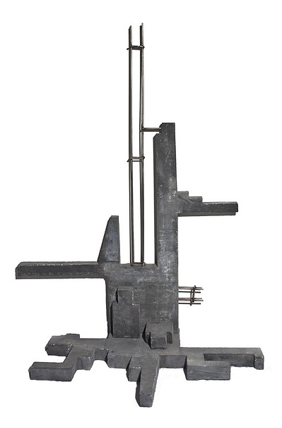 A dark monochromatic architectonic cubic sculpture made of cast concrete with white plaster that seems to grow organically from a corner up a wall and across the floor. Stainless steel is part of the construction.