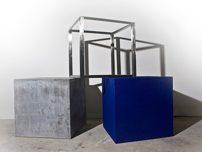 A sculpture made of 3 cubes: a cube made of stainless steel frame, a cube made of cast concrete and a cube painted purple