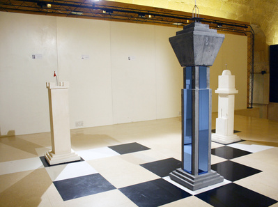 Over sized chess pieces form an installation made of building construction materials