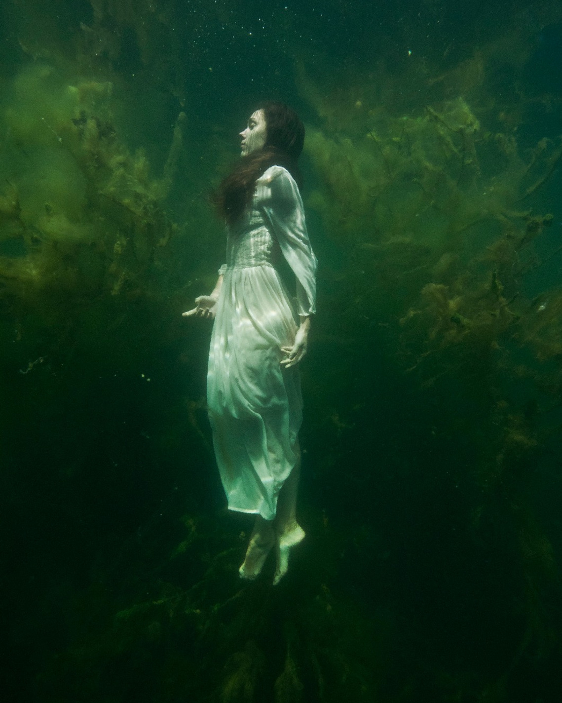 Full body underwater shot of underwater performance specialist Anima May, Lychen natural lake, Germany