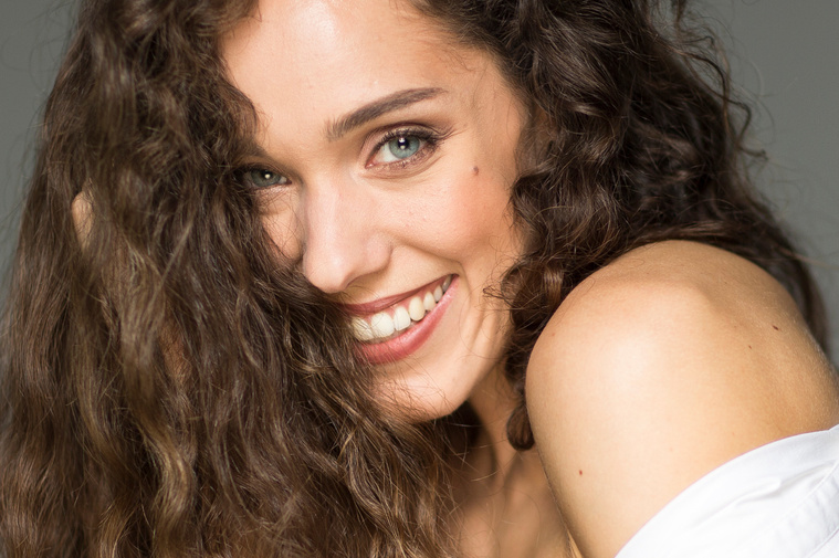 Smiling natural portrait of Swiss Italian performing artist and actress Anima May, Berlin