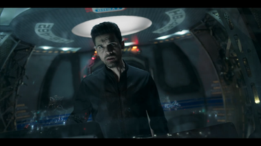 Actor stands in the spherical pod. Image shows ceiling lighting details, the decals and some of the side setting.