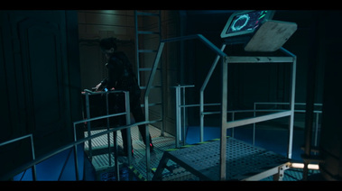 Metal walkway, with a ladder and a platform leading to a console.