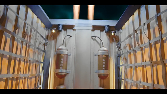 Man has ejected from the shipping container with his chair. You can see fuel tanks and struts that have been welded into the small container behind.