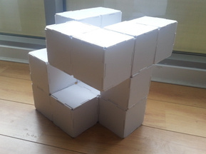 Foam model of speaker concept. Form is made from a 3 x 3 'cube' with many missing blocks. The edges of each 'bloc' fit together like a jigsaw.