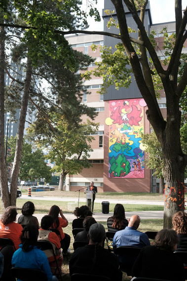 Darren Thomas, vice-president of indigenous initiatives at Wilfrid Laurier University speaks to the crowd at the Laurier Library indigenous mural unveiling.