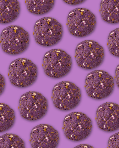 Taro, cornflake, and mochi cookies repeating in diagonal lines across the frame. Purple  background. Image shot by Megan Morello, San Diego and Southern California Food and Photographer.