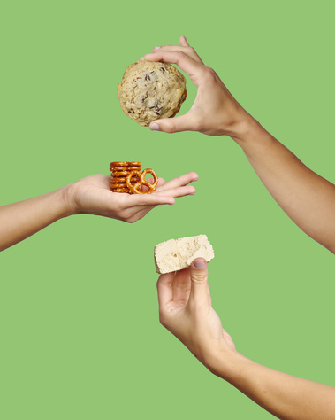 Three hands in frame holding halve and pretzel cookie and relevant ingredients. Yellow Green  background. Image shot by Megan Morello, San Diego and Southern California Food and Photographer.