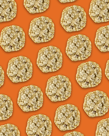 Chocolate Chip & Sea Salt cookies repeating in diagonal lines across the frame. Orange background. Image shot by Megan Morello, San Diego and Southern California Food and Photographer.