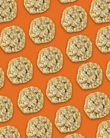 Chocolate Chip & Sea Salt cookies repeating in diagonal lines across the frame. Orange background. Image shot by Megan Morello, San Diego and Southern California Food and Photographer.