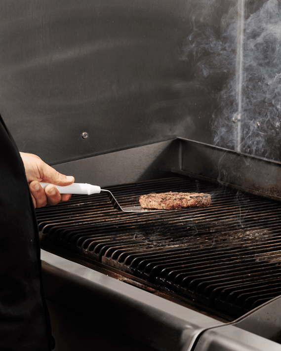 Stop motion animation of burger being flipped on the grill. Smoke visible. Image by Megan Morello San Diego Food and Lifestyle Photographer.